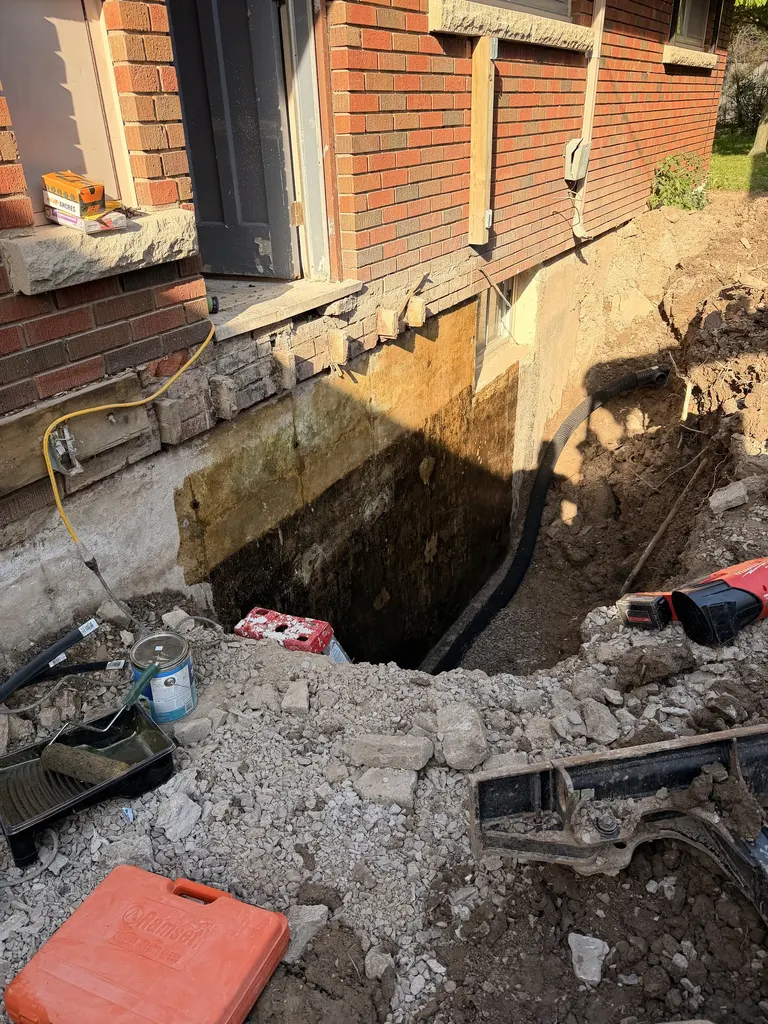 Excavation exposing a foundation wall for exterior work