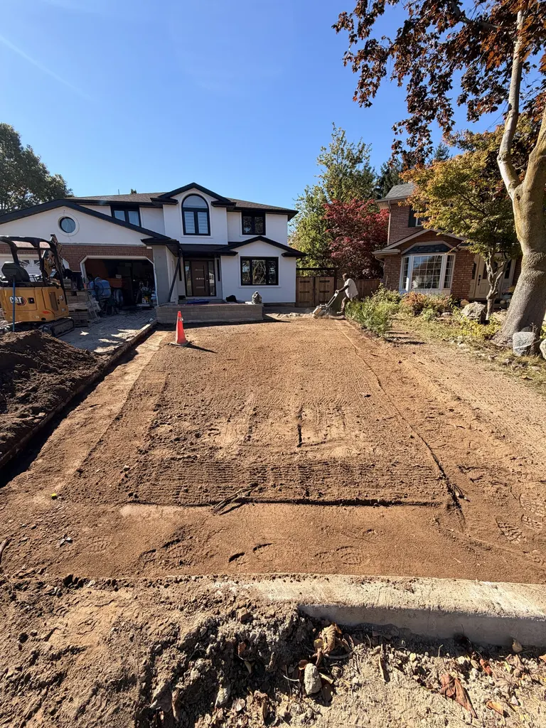 Graded and compacted granular base prepared for a new driveway
