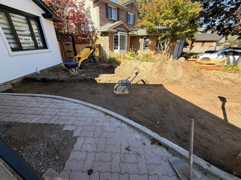 Compacting the base beside an interlock edge