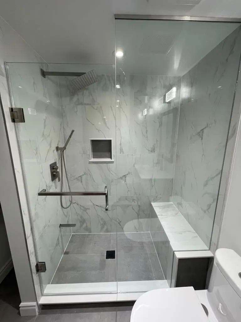 Large glass shower with built-in bench and niche