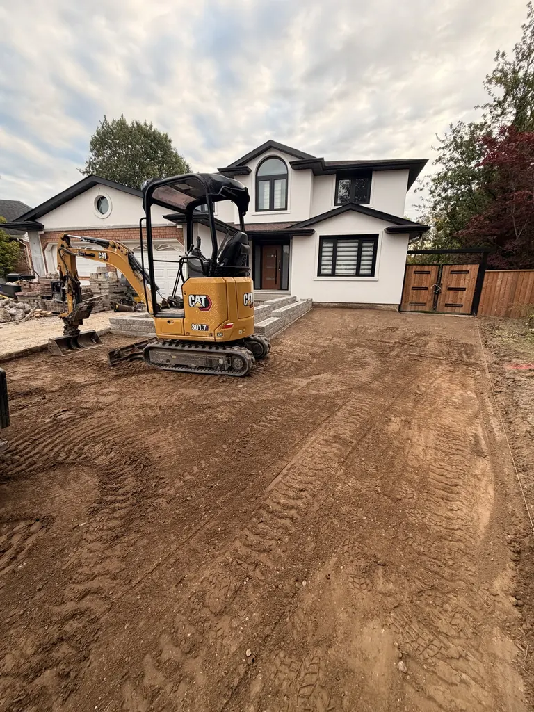 Mini excavator grading a front yard to level
