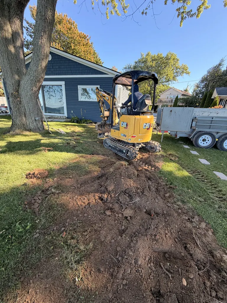 Mini excavator working in a waterfront backyard